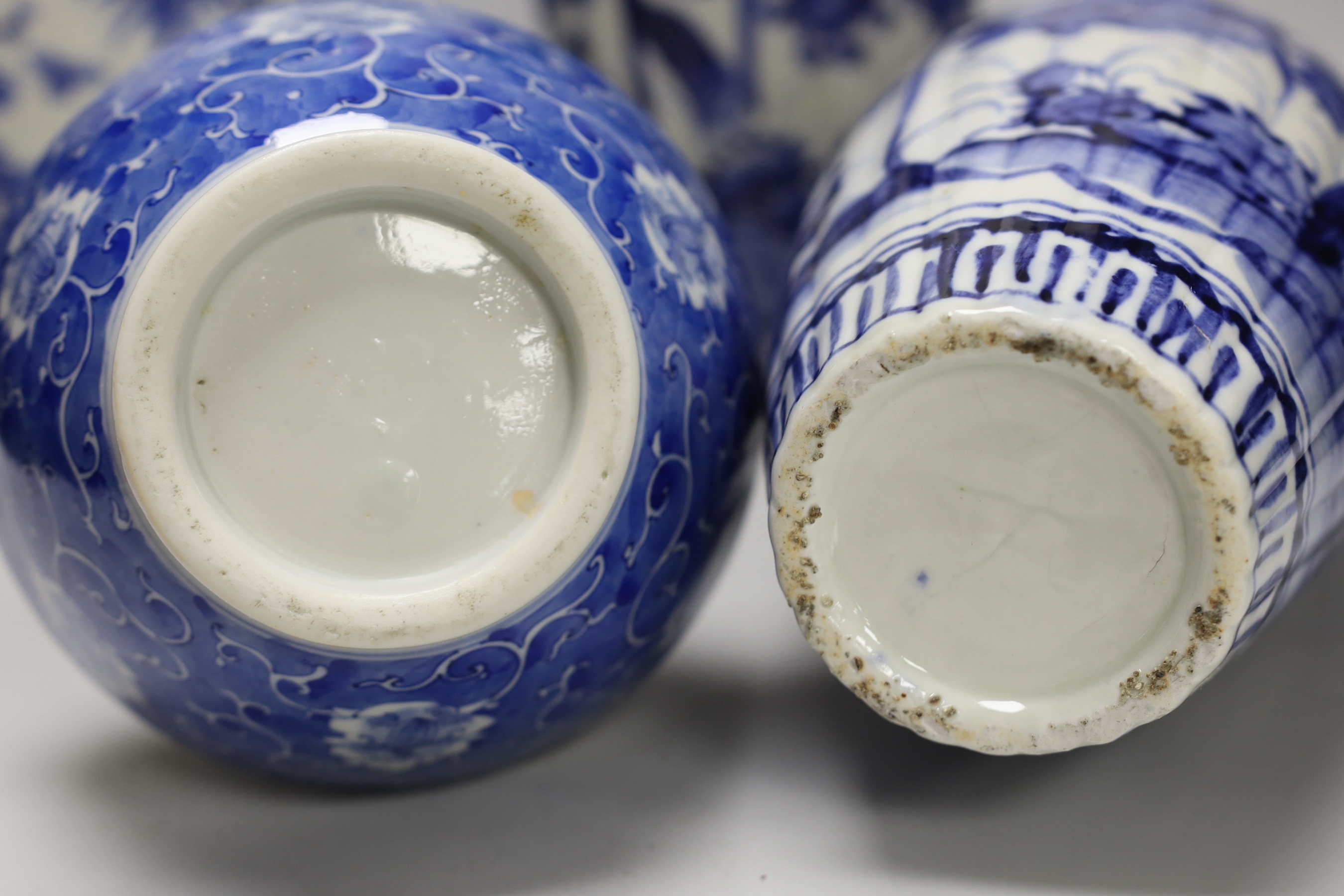 A pair of Japanese blue and white birds and flowers pattern vases and two other vases, tallest 39cm high